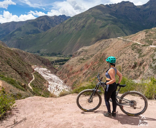 Arrive by bike at a viewpoint with spectacular views. Look down the canyon leading to the Maras Salt Mines, the highlight of your full-day cycling adventure.
